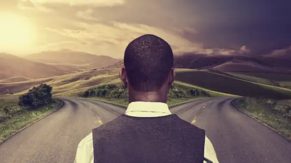 businessman in front of two roads hoping for best taking chance.jpeg