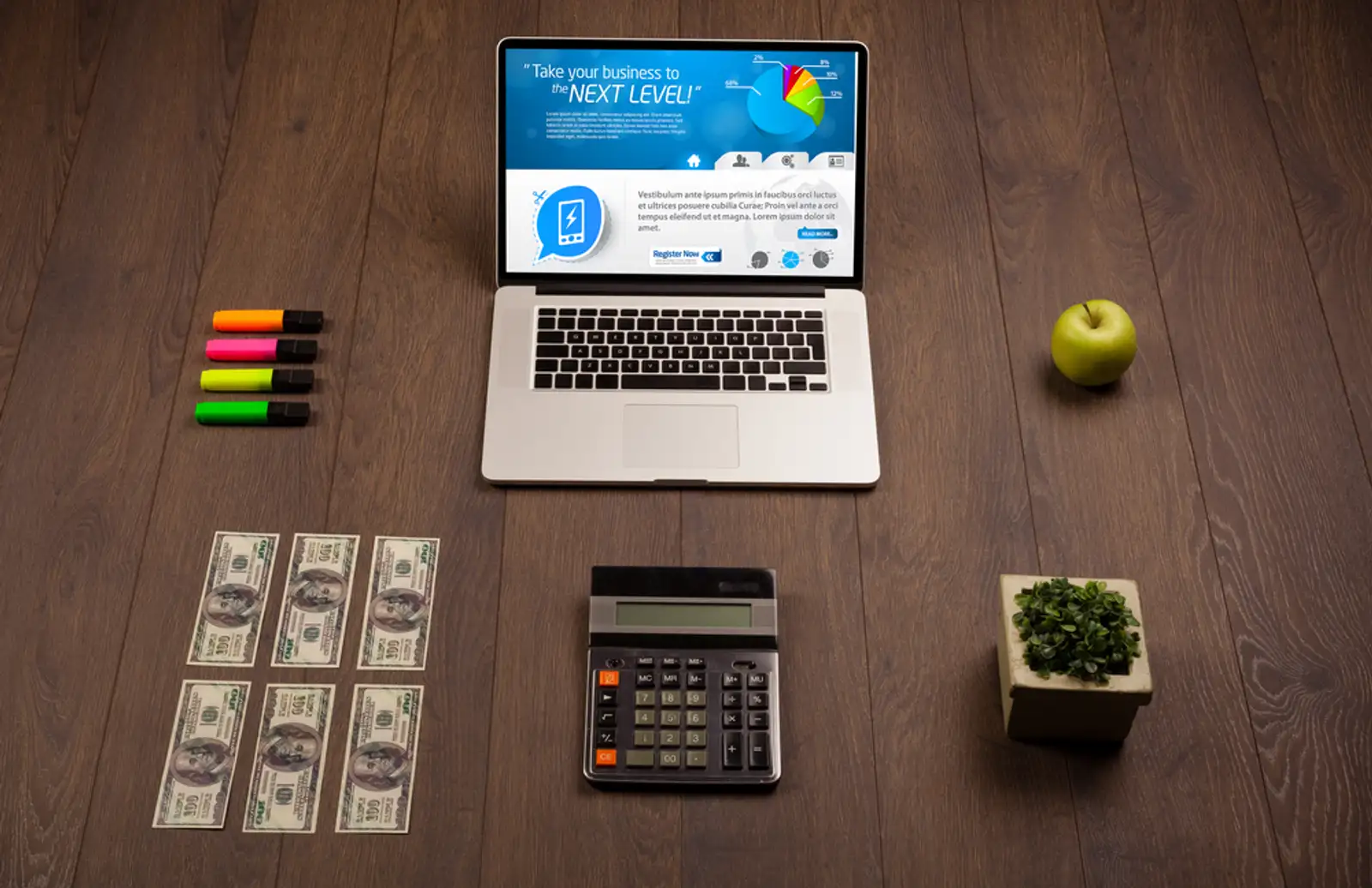 Laptop on office wooden desk with business website on screen.jpeg
