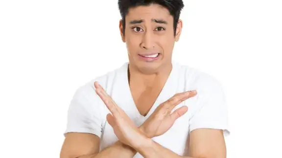 Closeup portrait%2c worried young man showing x sign to stop talking%2c cut it out%2c dont go there%2c isolated white background. Negative emotion facial expression feelings%2c signs symbols%2c body language.jpeg