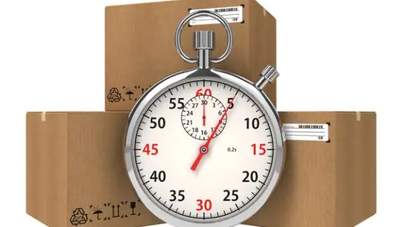 Stopwatch Over a Carton Boxes. Express Delivery Concept..jpeg