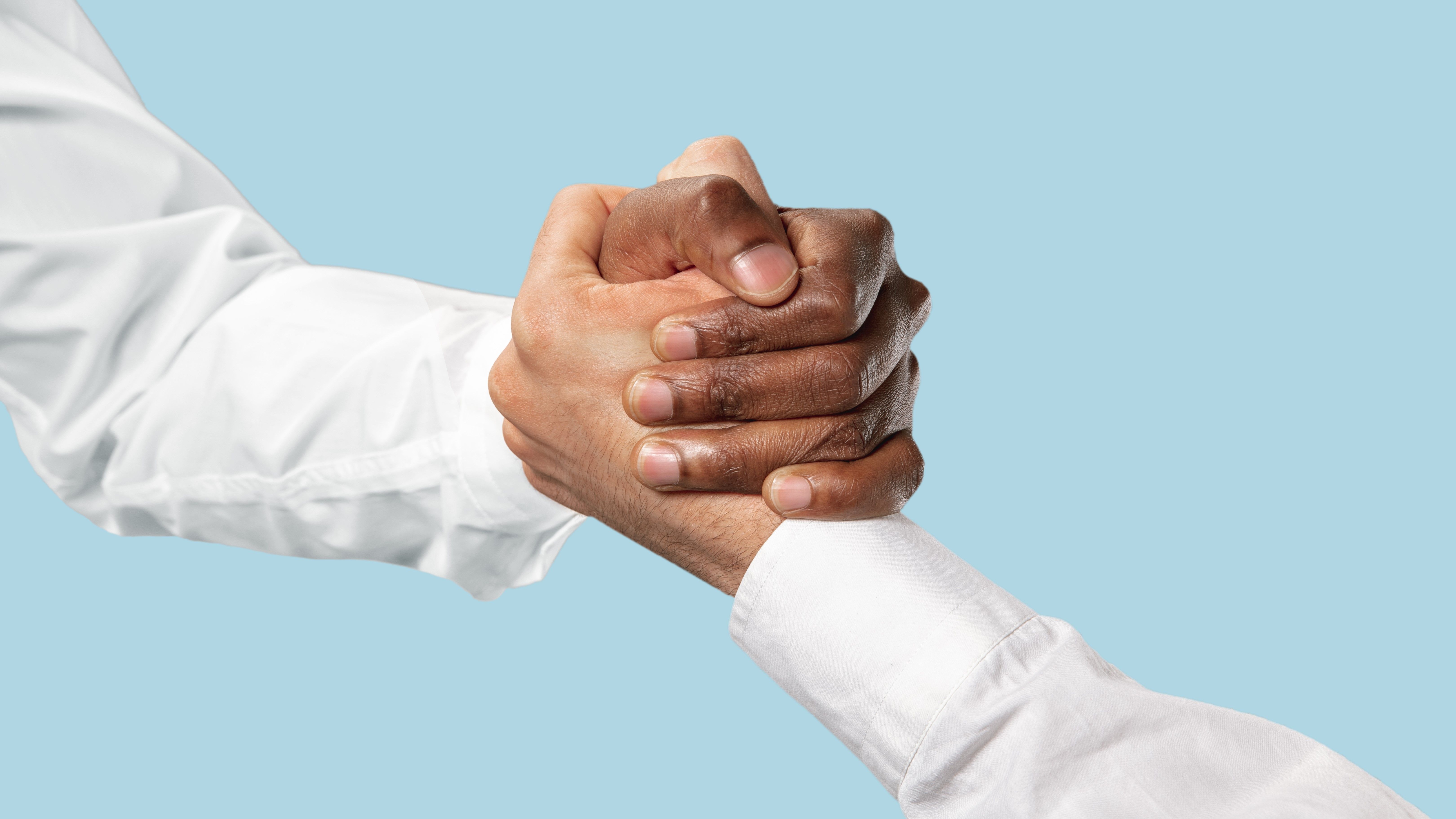 friends-greetings-sign-or-disagreement-two-male-hands-competion-in-arm-wrestling-isolated-on-blue-studio-background-concept-of-standoff-support-friendship-business-community-strained-relations.jpg