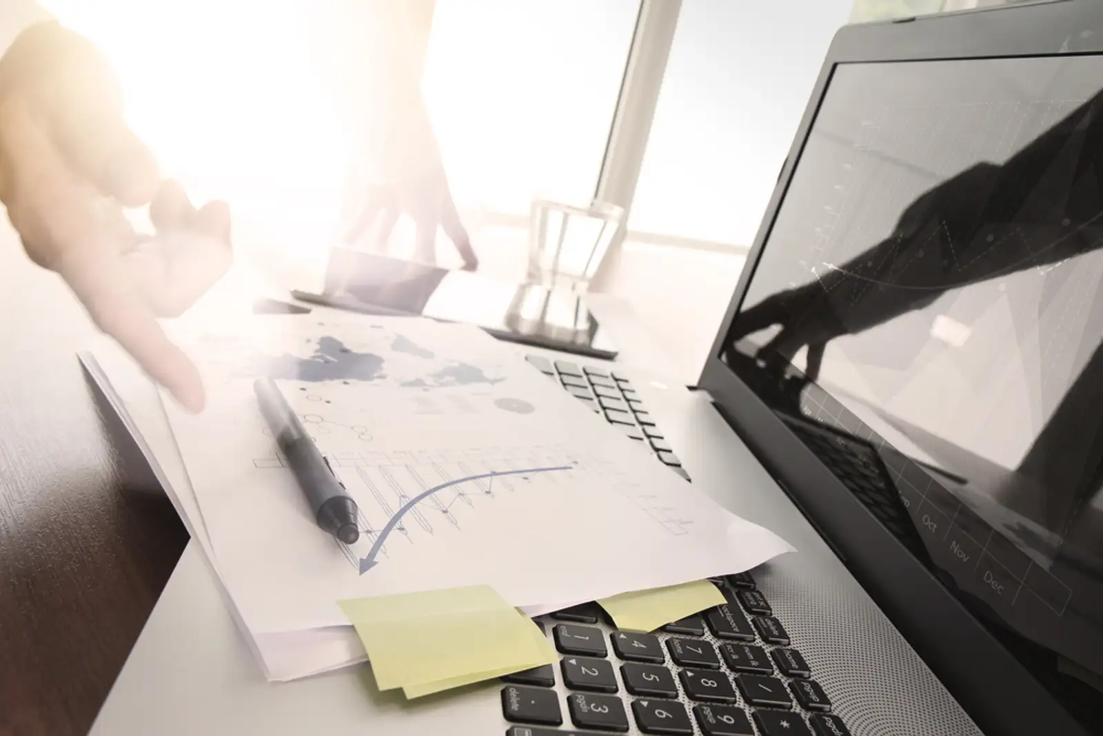 Close up of business man hand working on laptop computer with social media diagram and chart graph on wooden desk as concept.jpeg