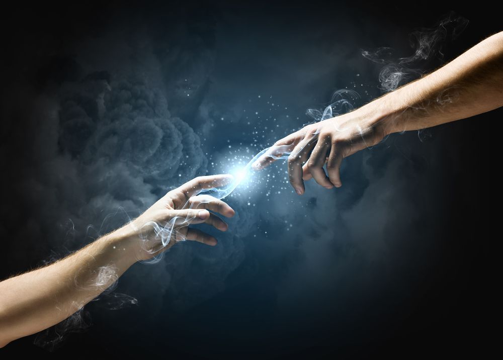 Michelangelo Gods touch. Close up of human hands touching with fingers.jpeg