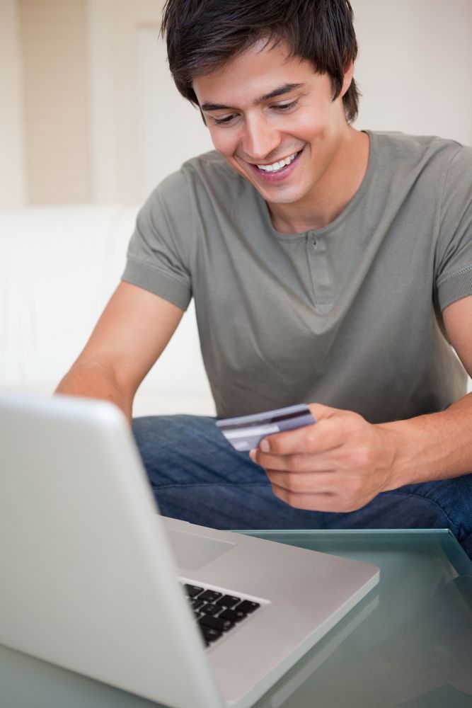 Portrait of a young man shopping online in his living room.jpeg