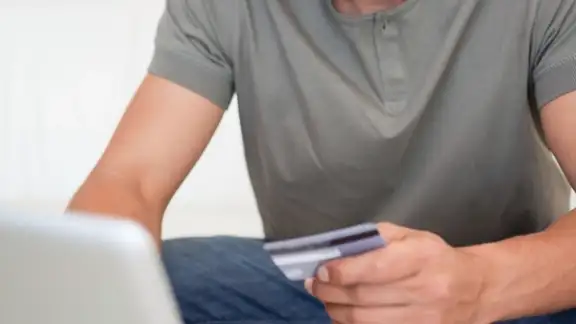 Portrait of a young man shopping online in his living room-1.jpeg