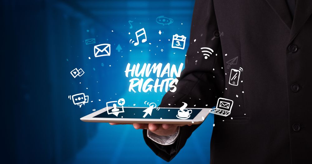 Young business person working on tablet and shows the inscription HUMAN RIGHTS.jpeg