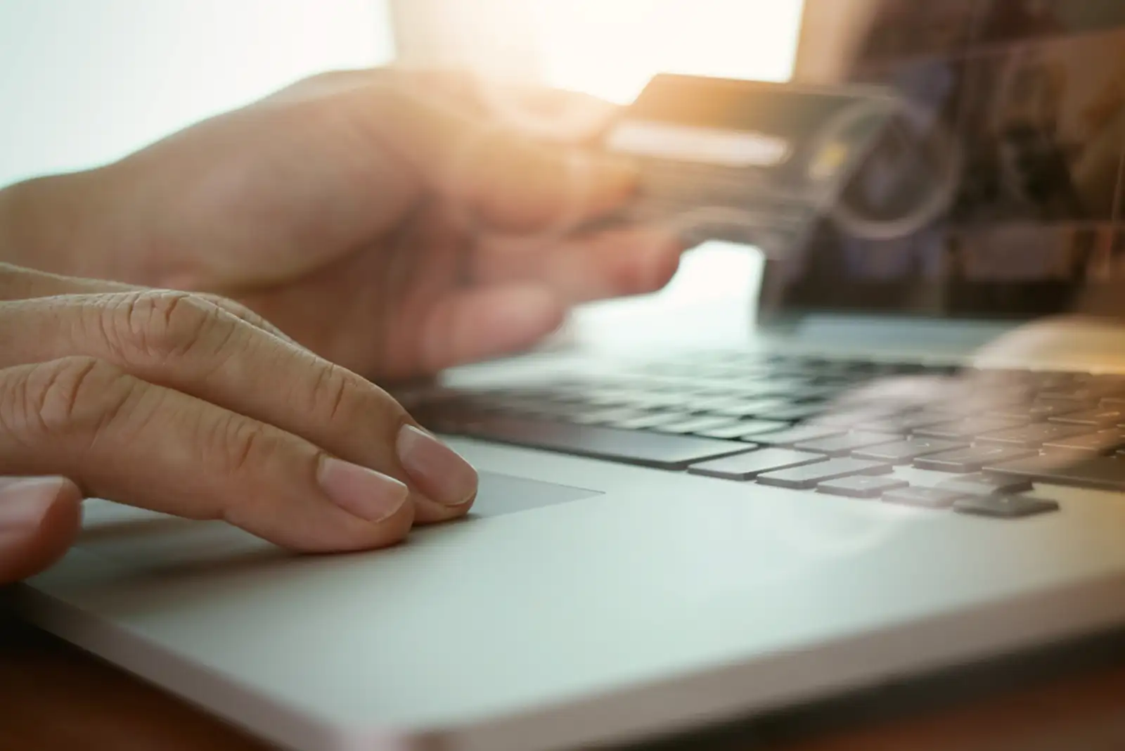 close up of hands using laptop and holding credit card as Online shopping concept.jpeg
