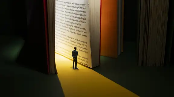 storytelling-uomo piccolo che legge libro gigante.jpg