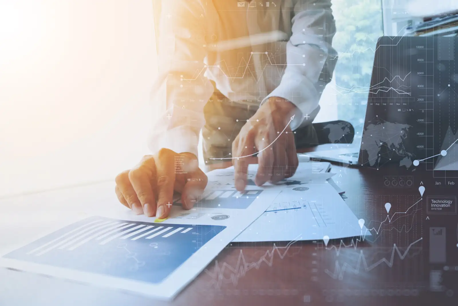 business documents on office table with smart phone and digital tablet and graph financial with social network diagram and man working in the background-1.jpeg
