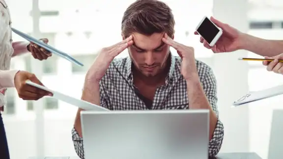 Businessman stressed out at work in casual office.jpeg