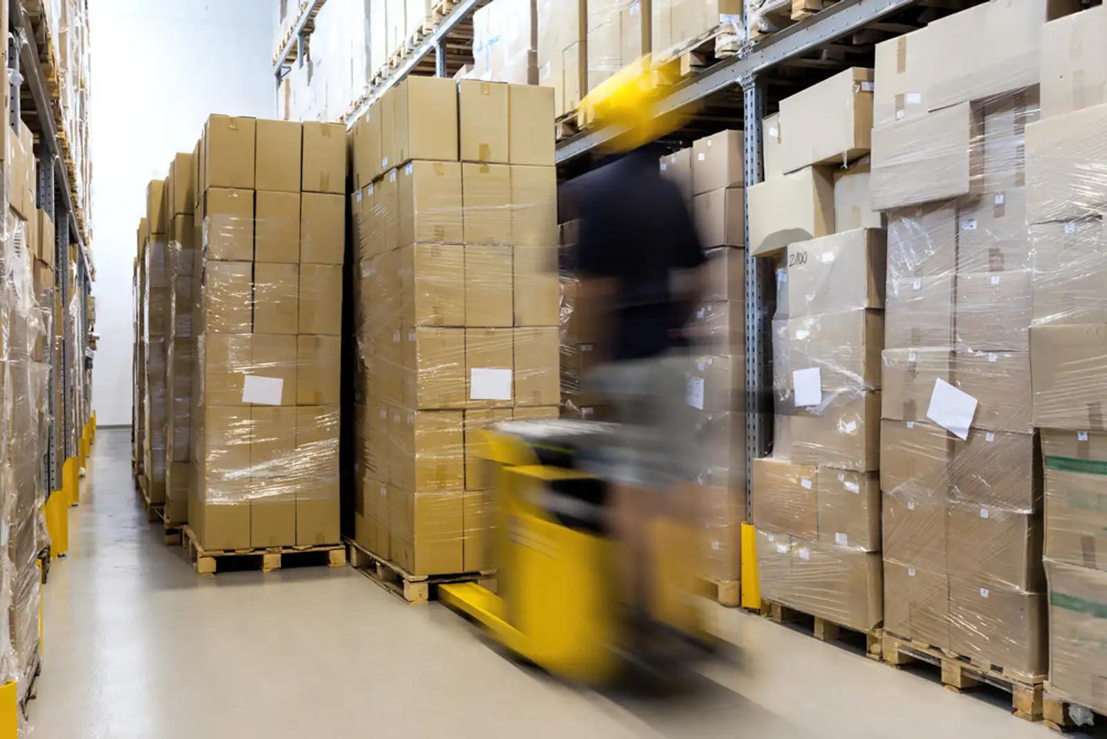 Fork lift with operator working in warehouse.jpeg