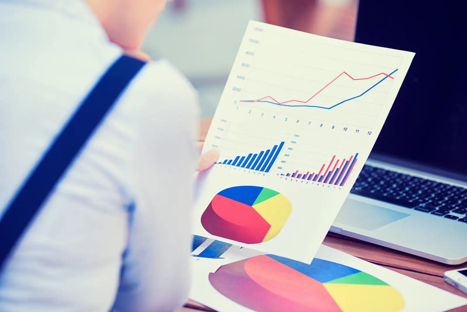 woman investment consultant analyzing company annual financial report balance sheet statement working with documents graphs. Stock market%2c office%2c tax%2c education concept. Hands with charts papers.jpeg