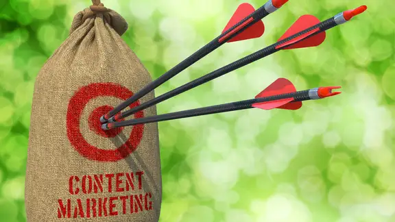 Content Marketing - Three Arrows Hit in Red Target on a Hanging Sack on Natural Bokeh Background..jpeg