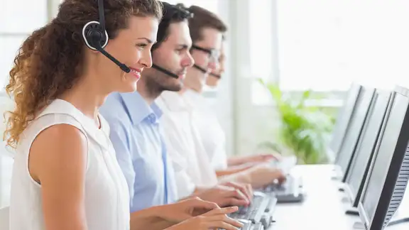 Customer service representatives working at desk in office.jpeg