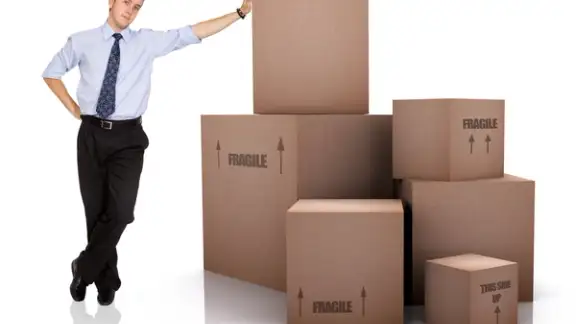 Businessman with Cardboard Boxes Over a White Background.jpeg