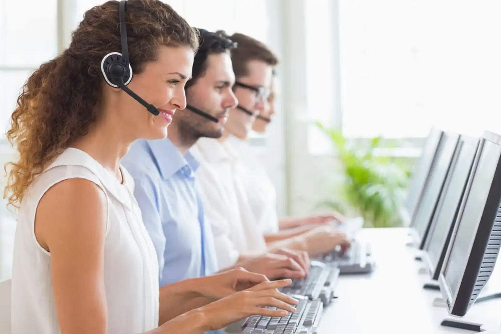 Customer service representatives working at desk in office.jpeg