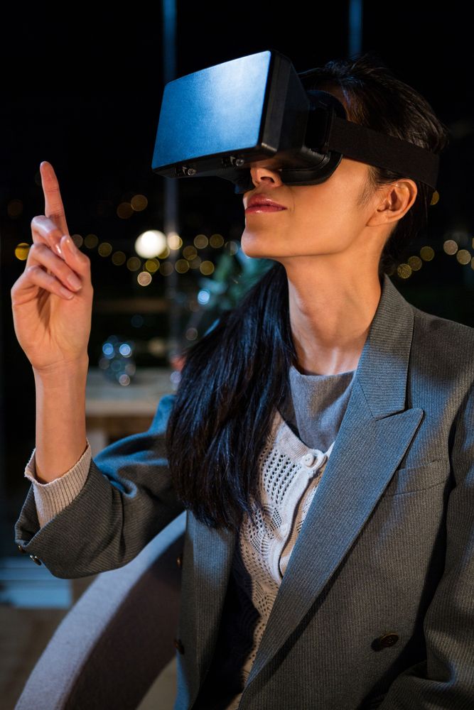 Businesswoman using virtual reality headset in the office.jpeg