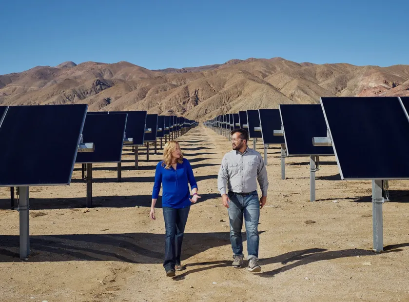 People chatting in the desert among solar arrays, as people do.