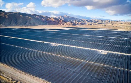 Aerial photo of solar arrays in desert.