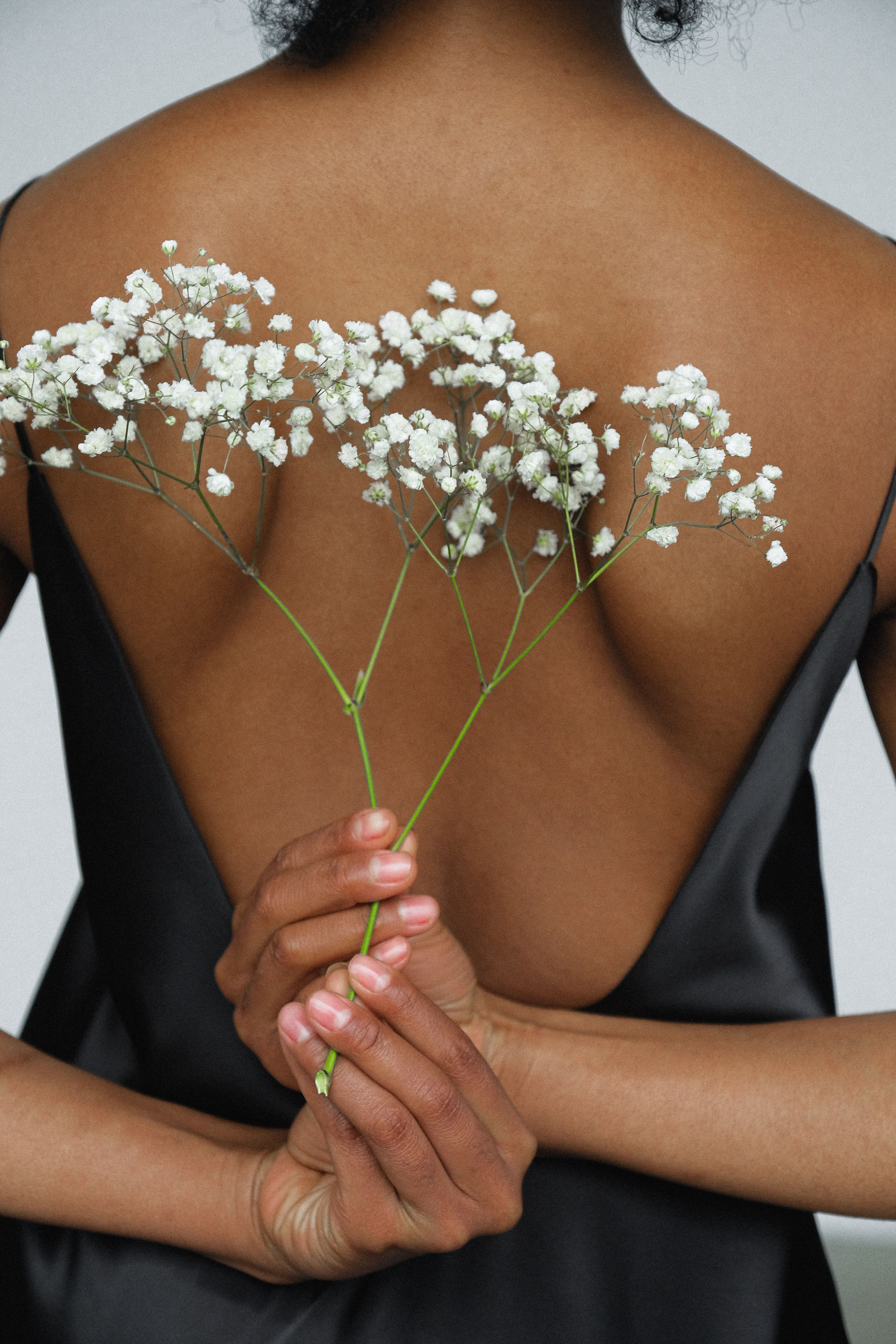close-up-photo-of-woman-in-black-night-dress-holding-white-3746309