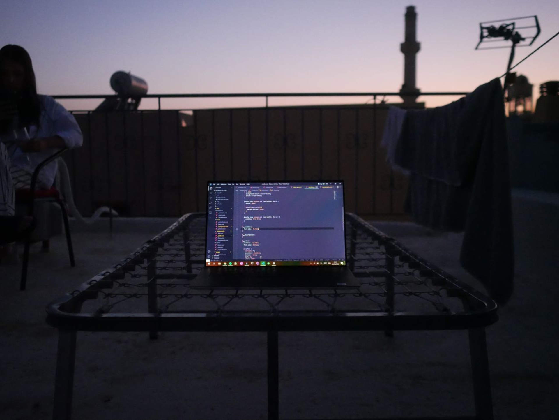 Laptop with lines of code on a roof terrace in Chania, Crete - shot by Lucian Chevallier