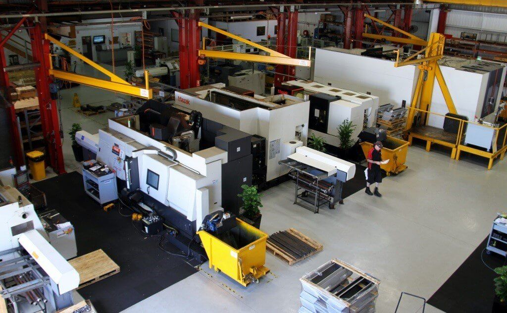 Interior of the Nupress workshop with man walking and CNC machines
