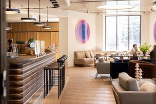 Interior of a bar with comfortable seating arrangements and large colourful spherical artworks on the walls