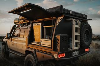 A utility vehicle with M2 Overland canopy at sunset in the countryside 