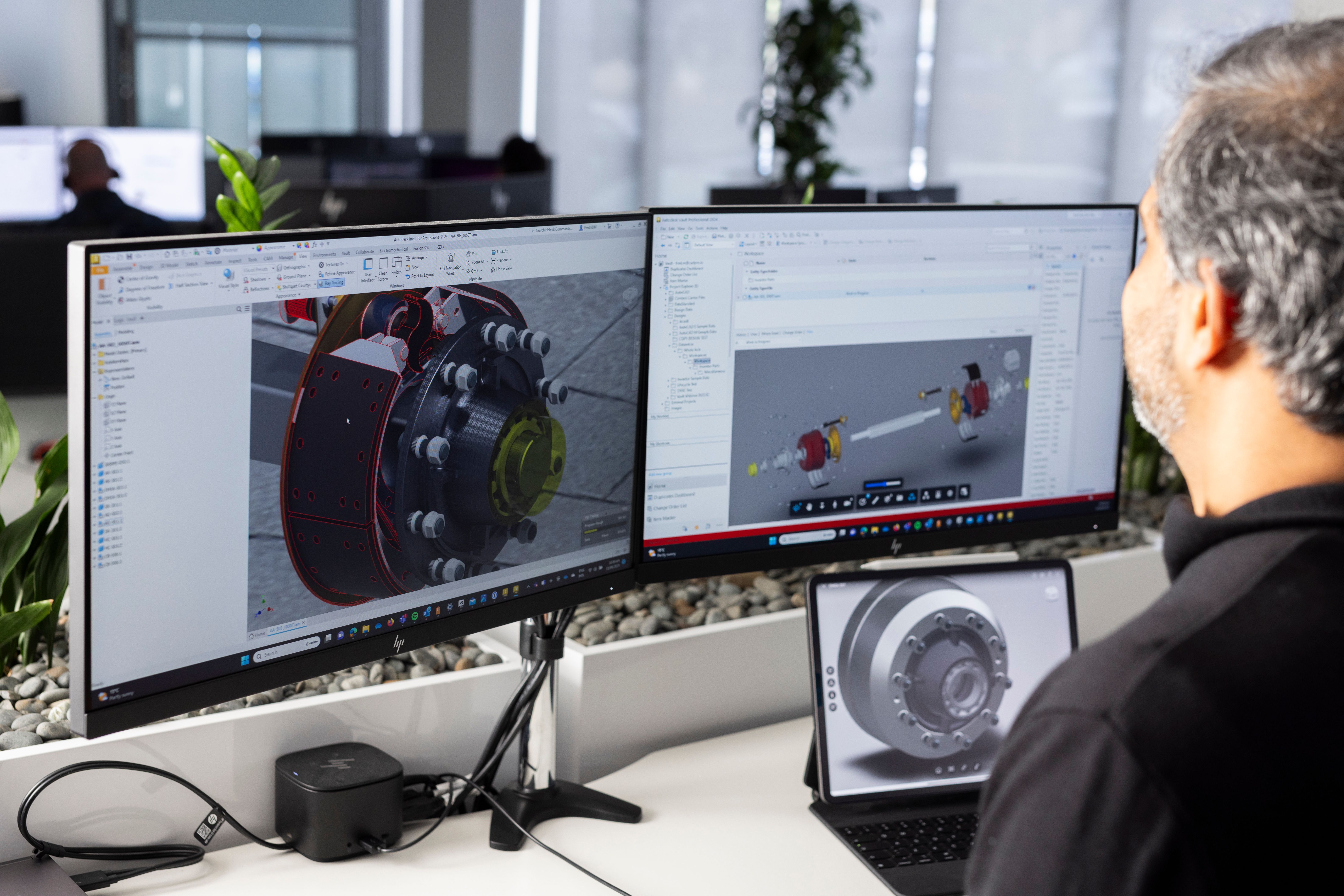 A man working on Autodesk Fusion 360 software
