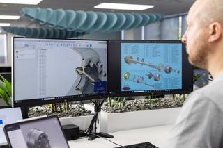 Man standing in front of a computer