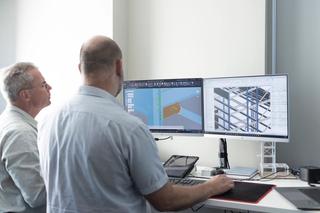 Two people viewing Autodesk Advance Steel models on a computer