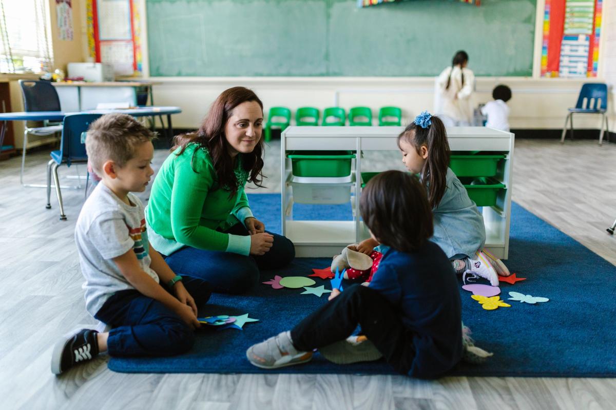 children & teacher in early years setting