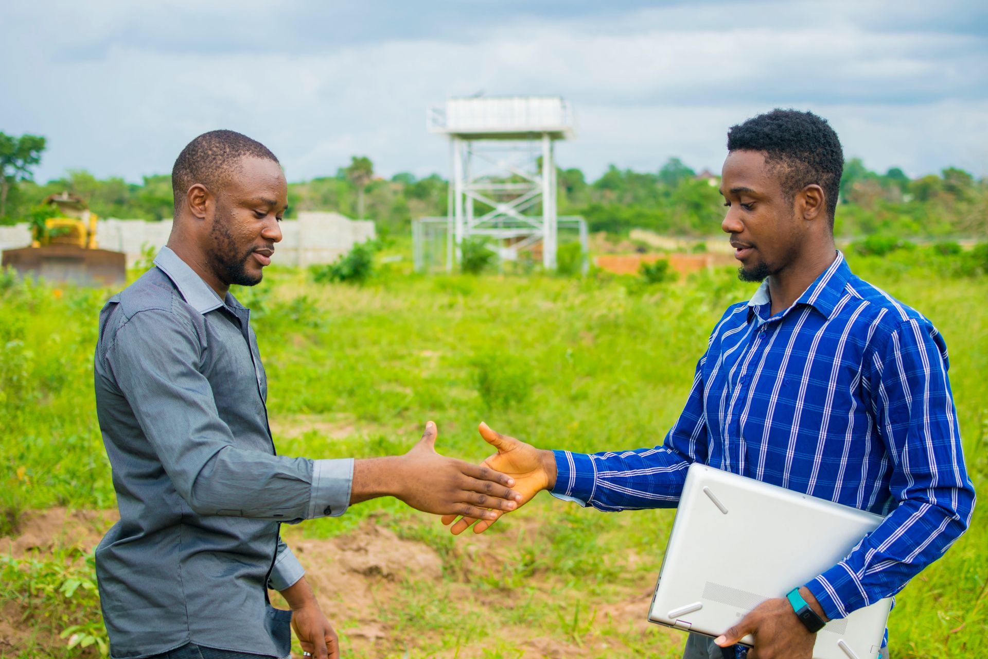 Close-up view of a notary stamping land title documents on a polished wooden desk illuminated by soft natural light, emphasizing legal assurance and transparent property transfer at Pikwe Estates.