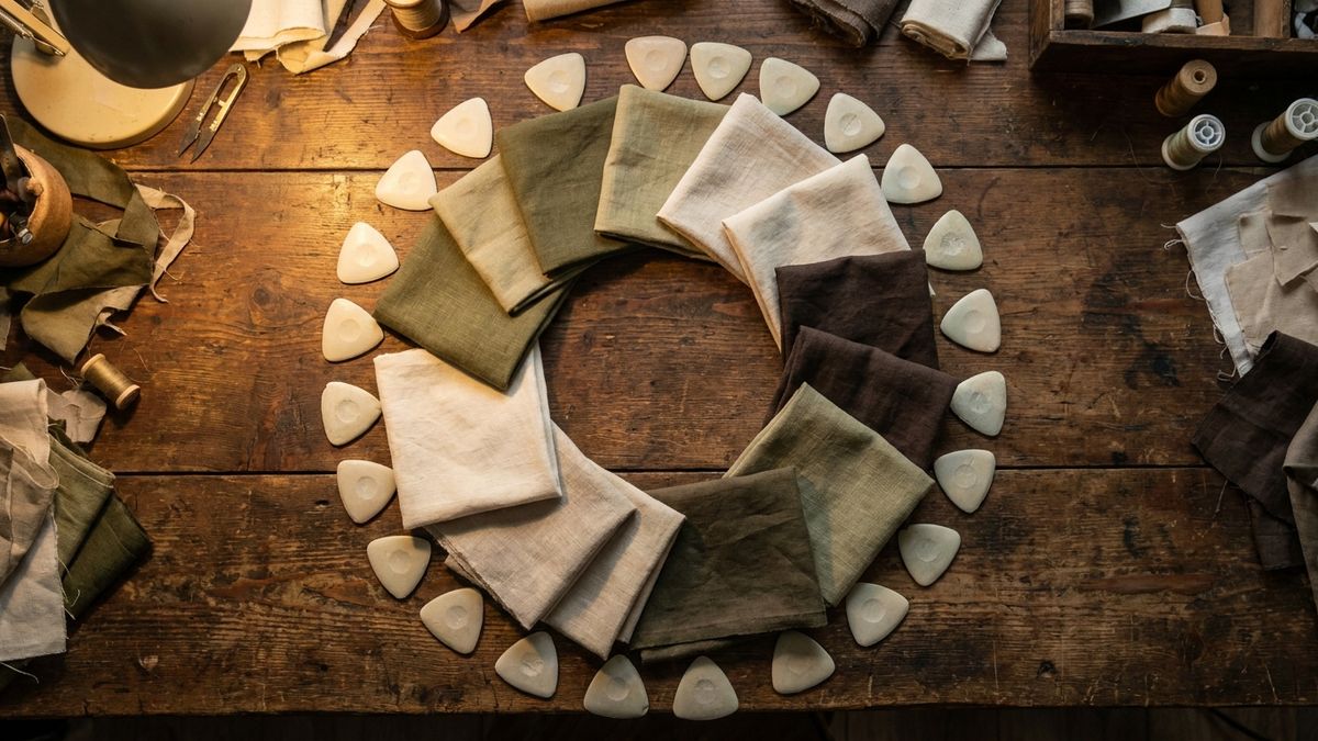Tailor chalk and community-cut cloth samples on dark wood