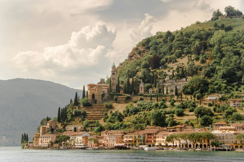 The picturesque village of Morcote on Lake Lugano with boats in harbour