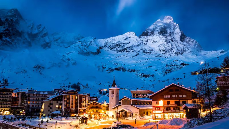 Cervinia ski resort illuminated at night with the Matterhorn backdrop