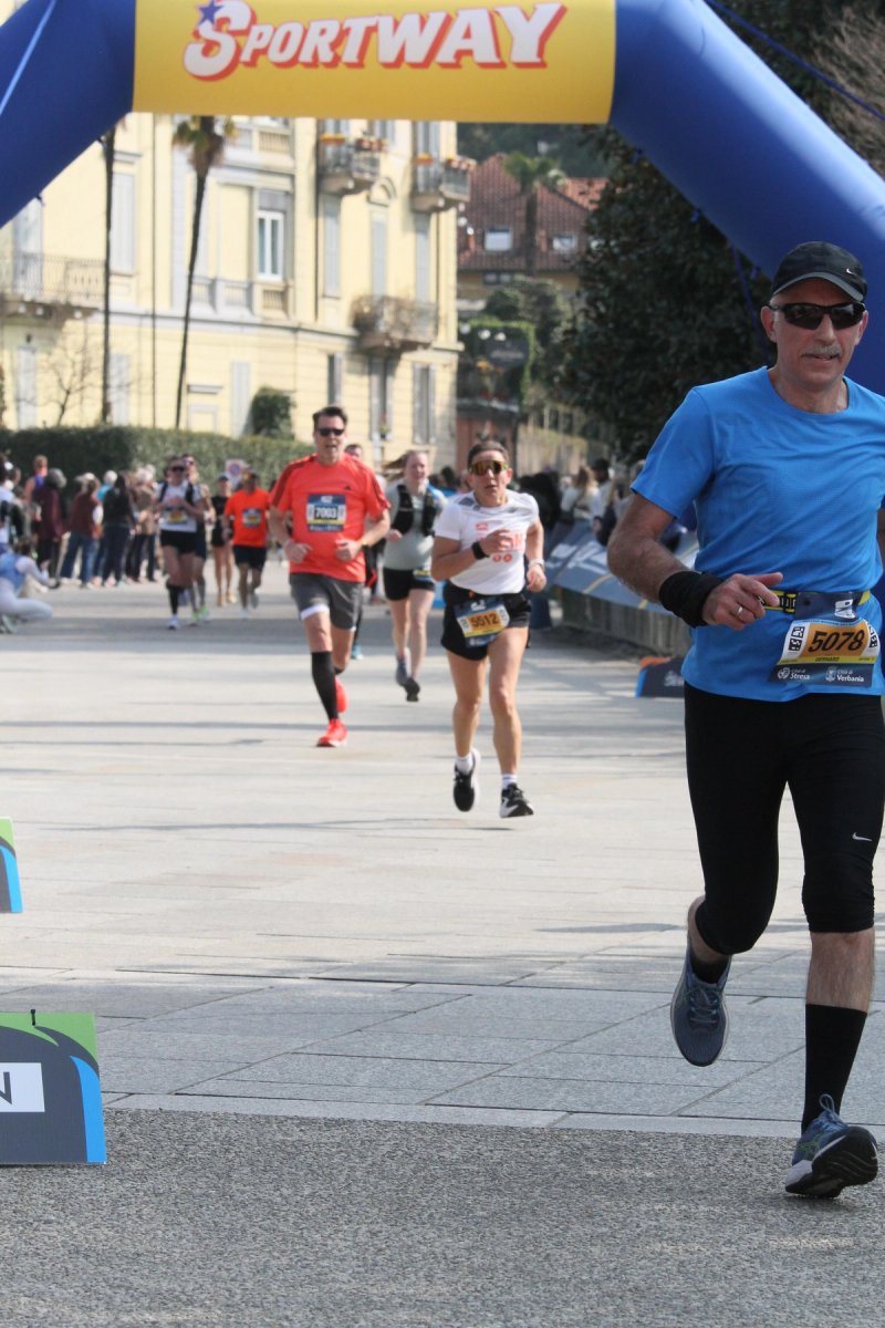 Runners crossing the finish line at the Lago Maggiore Marathon in Verbania-Pallanza