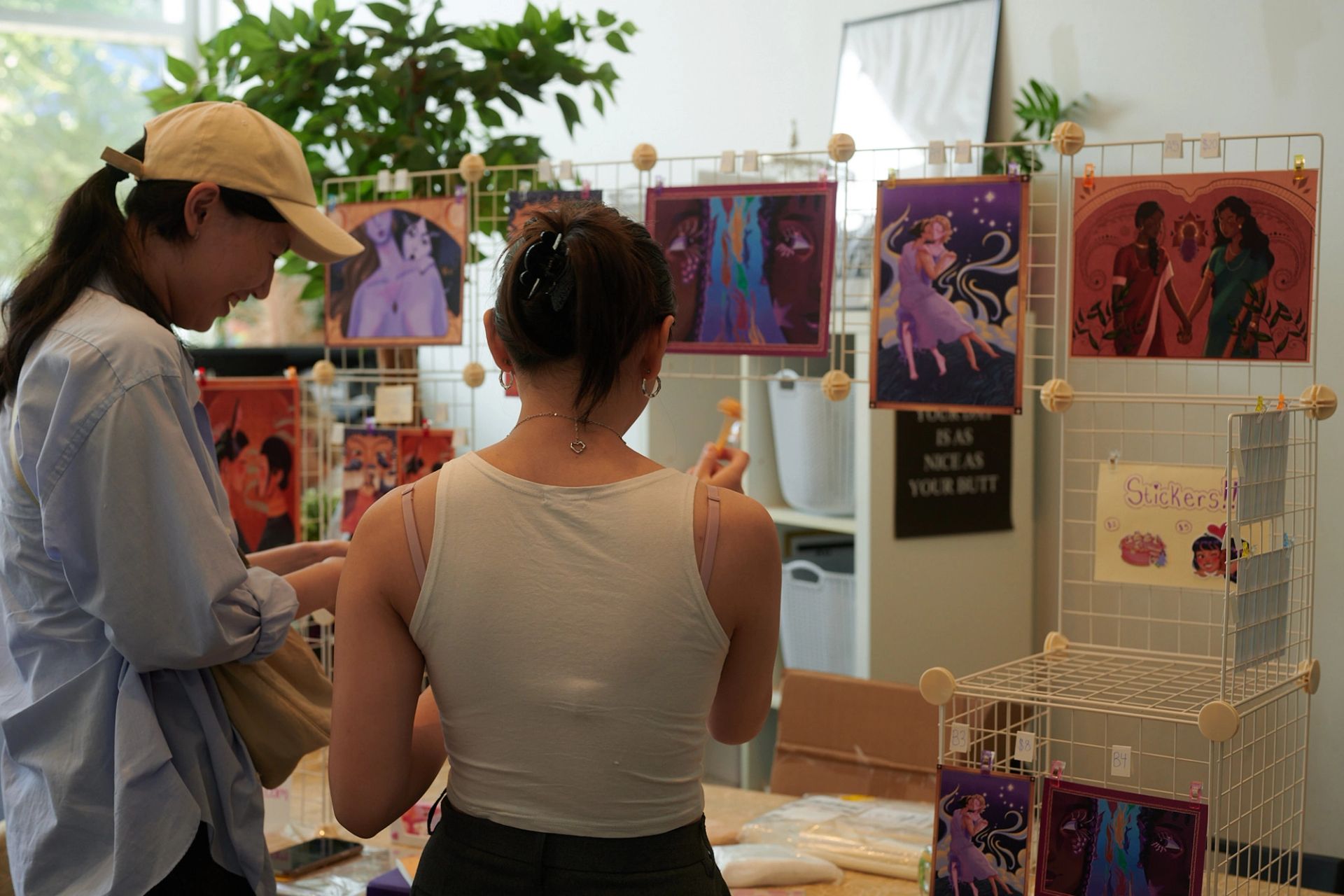 Two girls looking at artwork