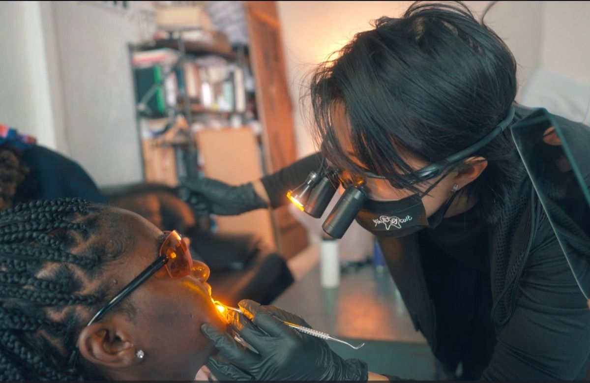 Dr. Jess applying a tooth gem