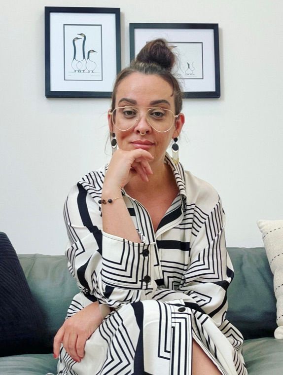 Dr. Kim Cullen, seated, wearing glasses and a striped shirt