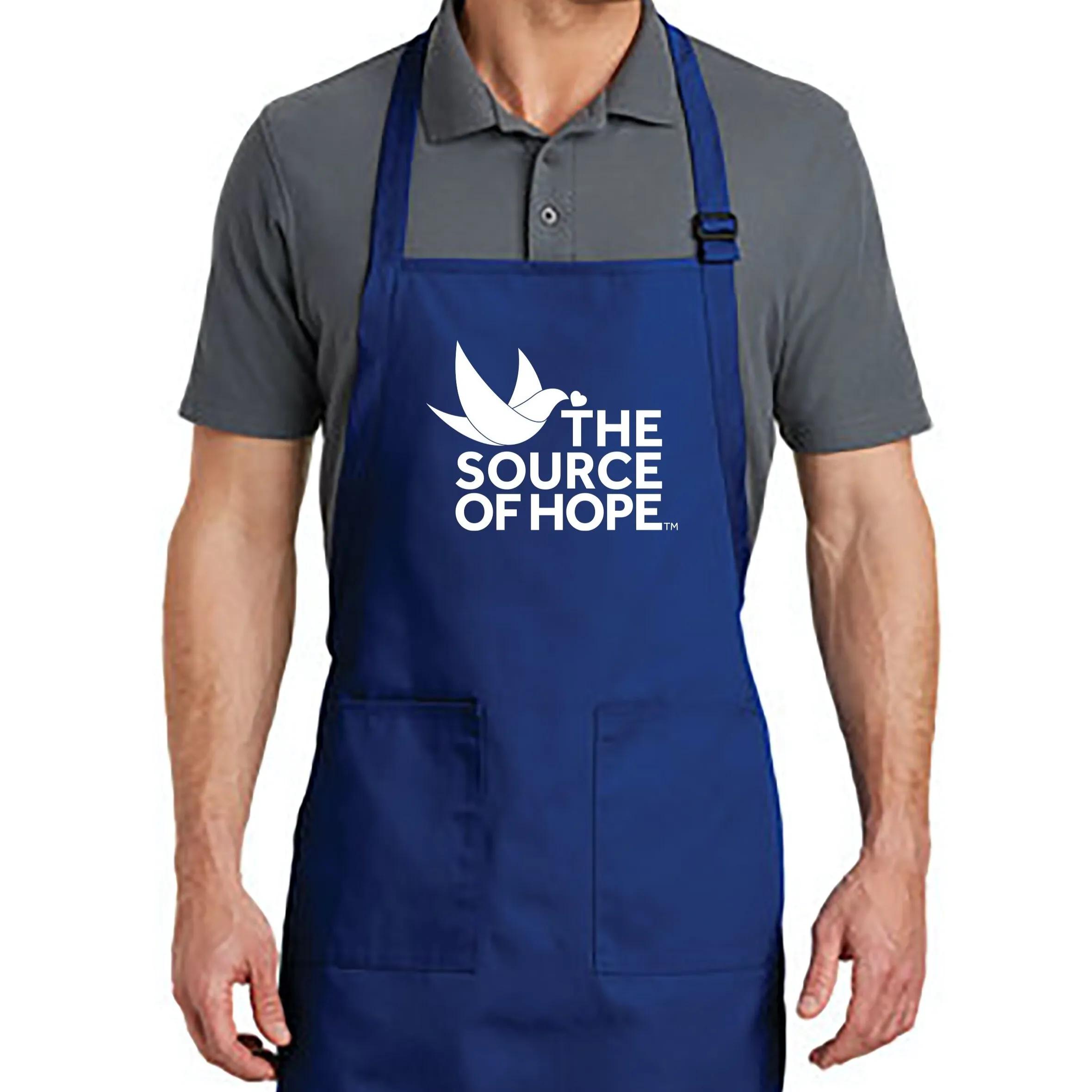 Blue The Source of Hope apron with white logo on the front, adjustable neck strap, and two large front pockets.