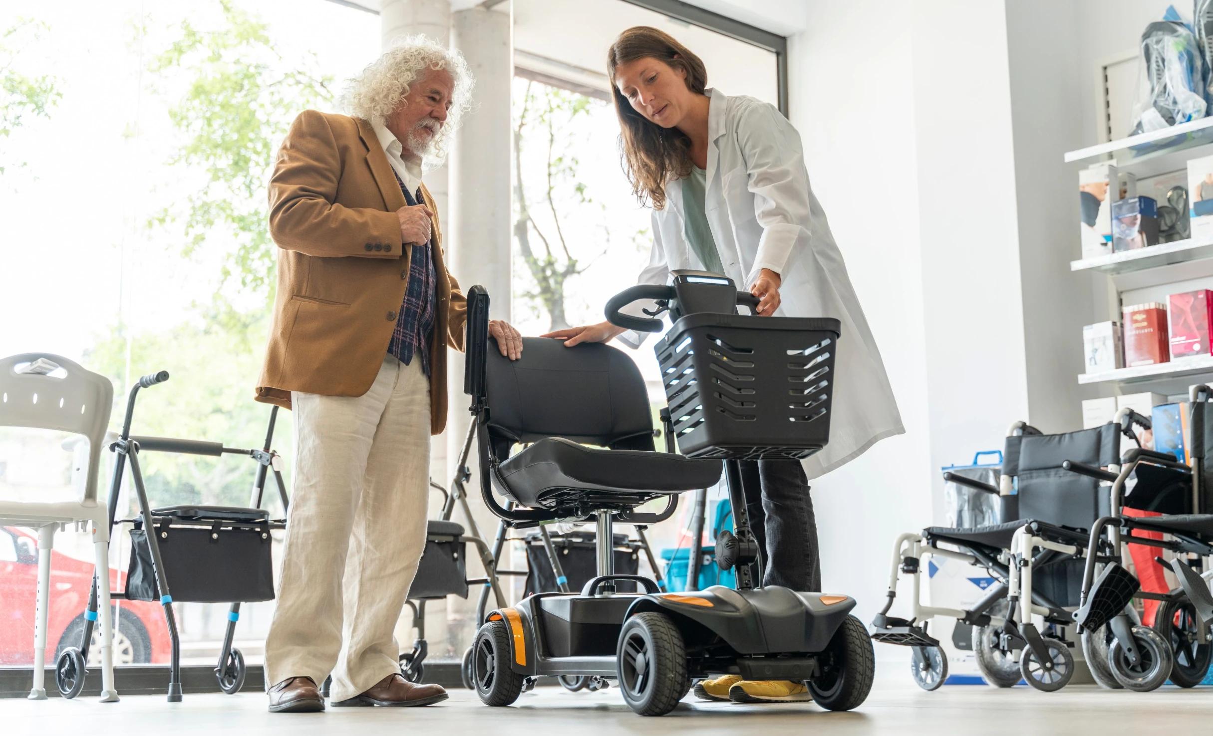 Elderly man with a walker in a mobility equipment showroom
