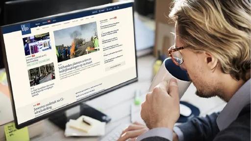 person working at a desk and drinking coffee