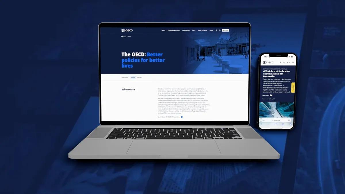 a laptop and phone showing our new OECD project