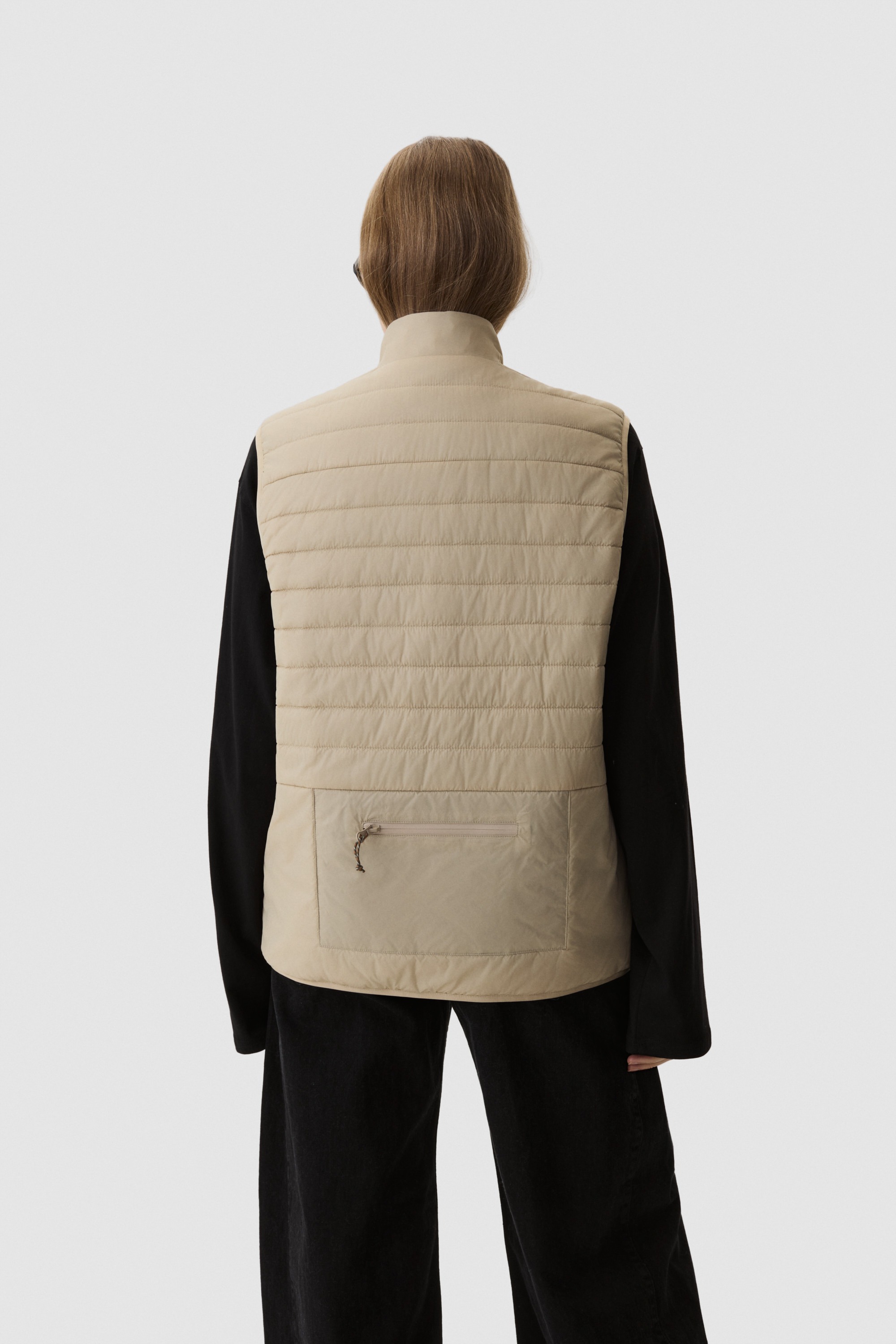 Model wearing Yama Traverse Puffer Vest Sand Dune