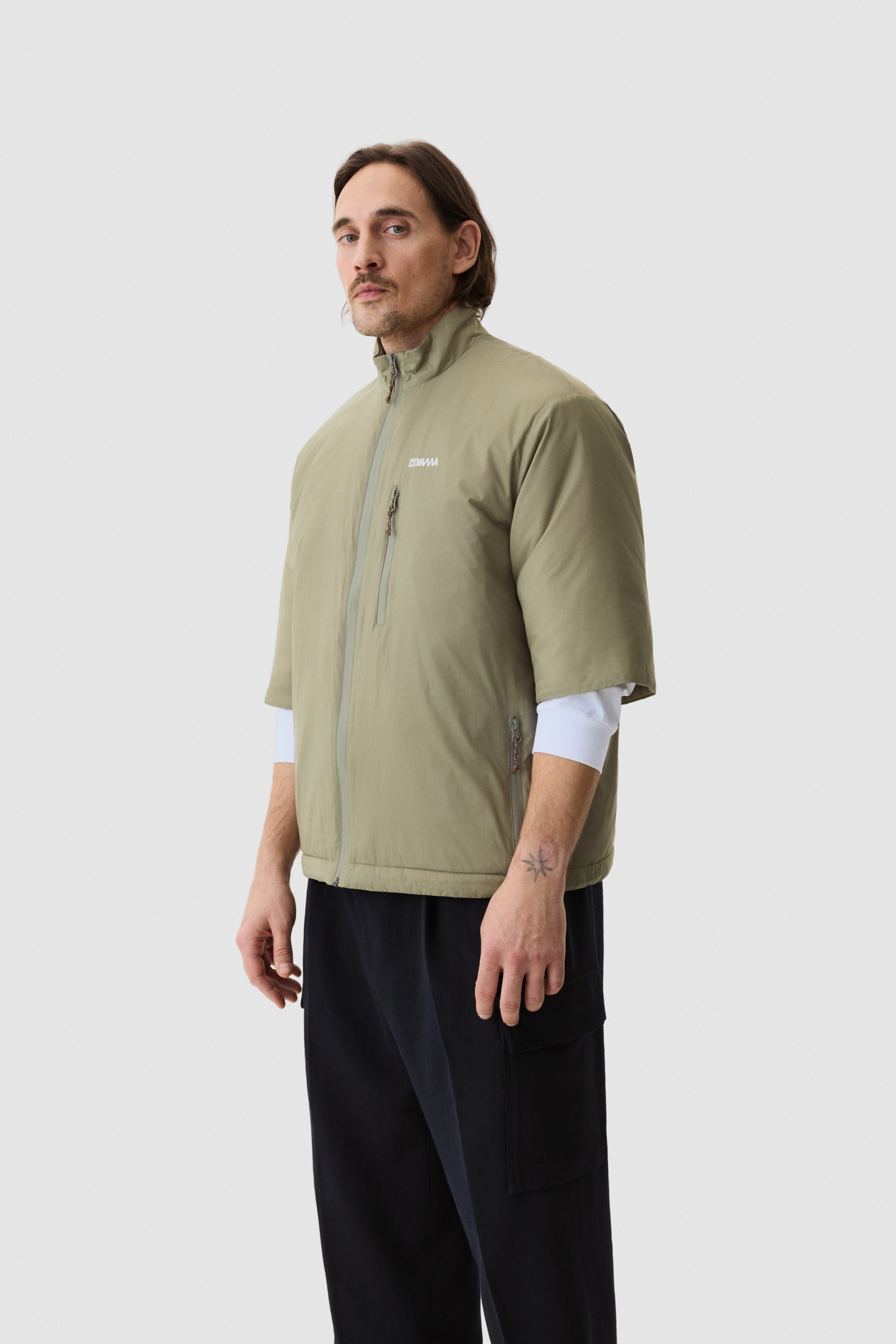 Model wearing Yama Strata Plain Jacket Moss Green