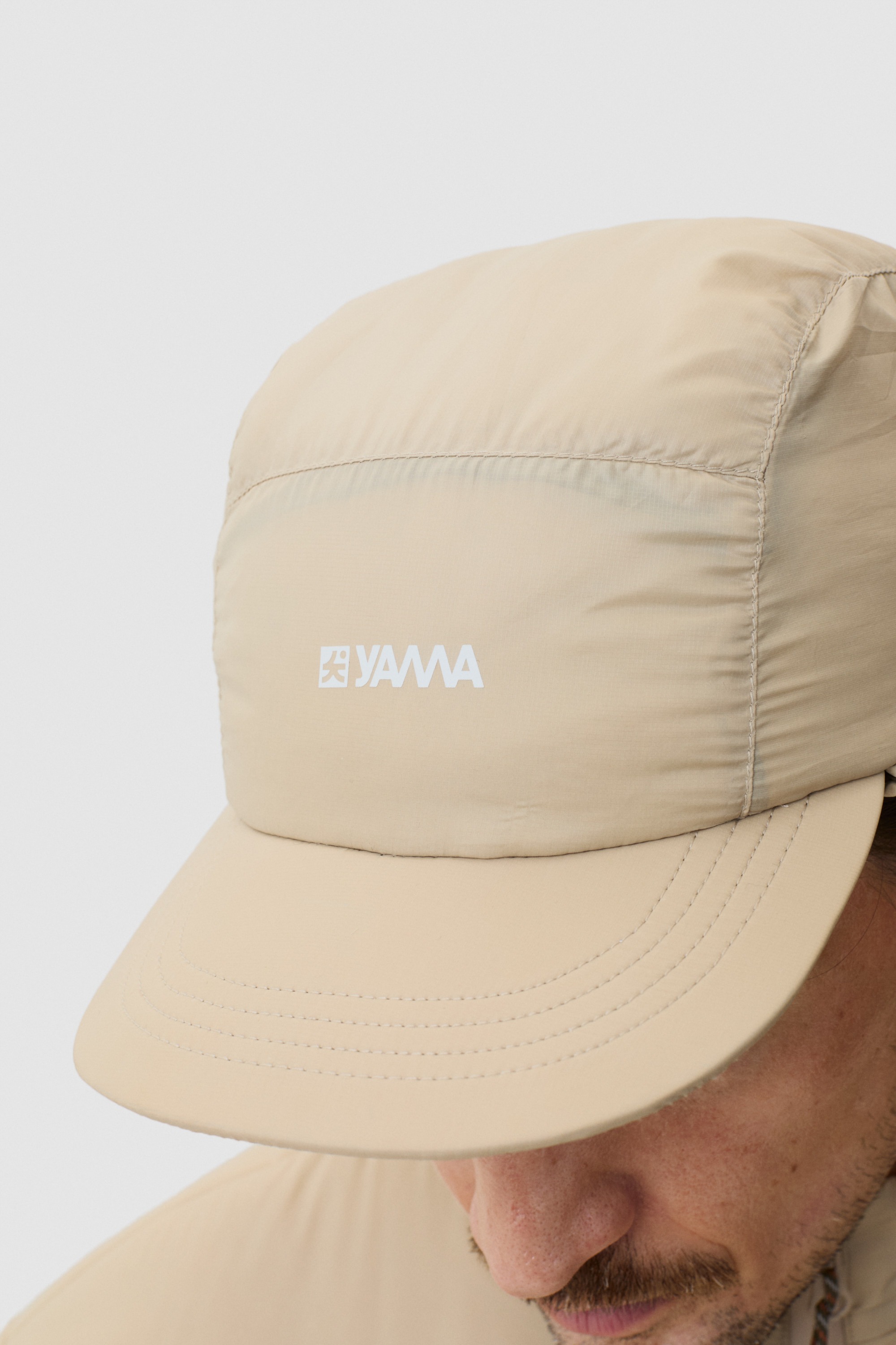 Model wearing Yama Vertex Cap Sand Dune