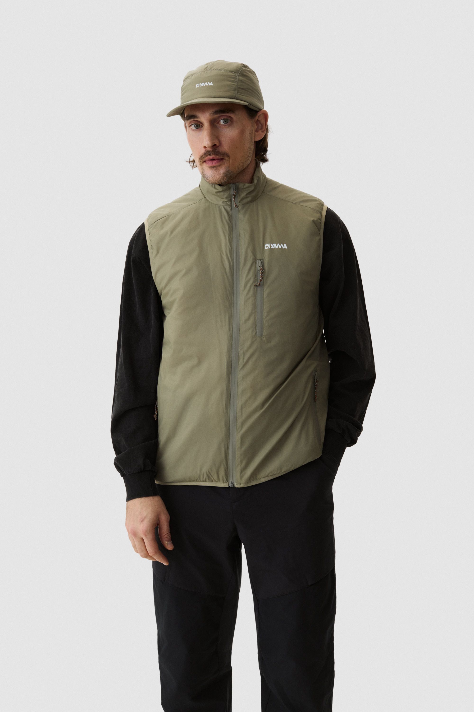 Model wearing Yama Traverse Plain Vest Moss Green