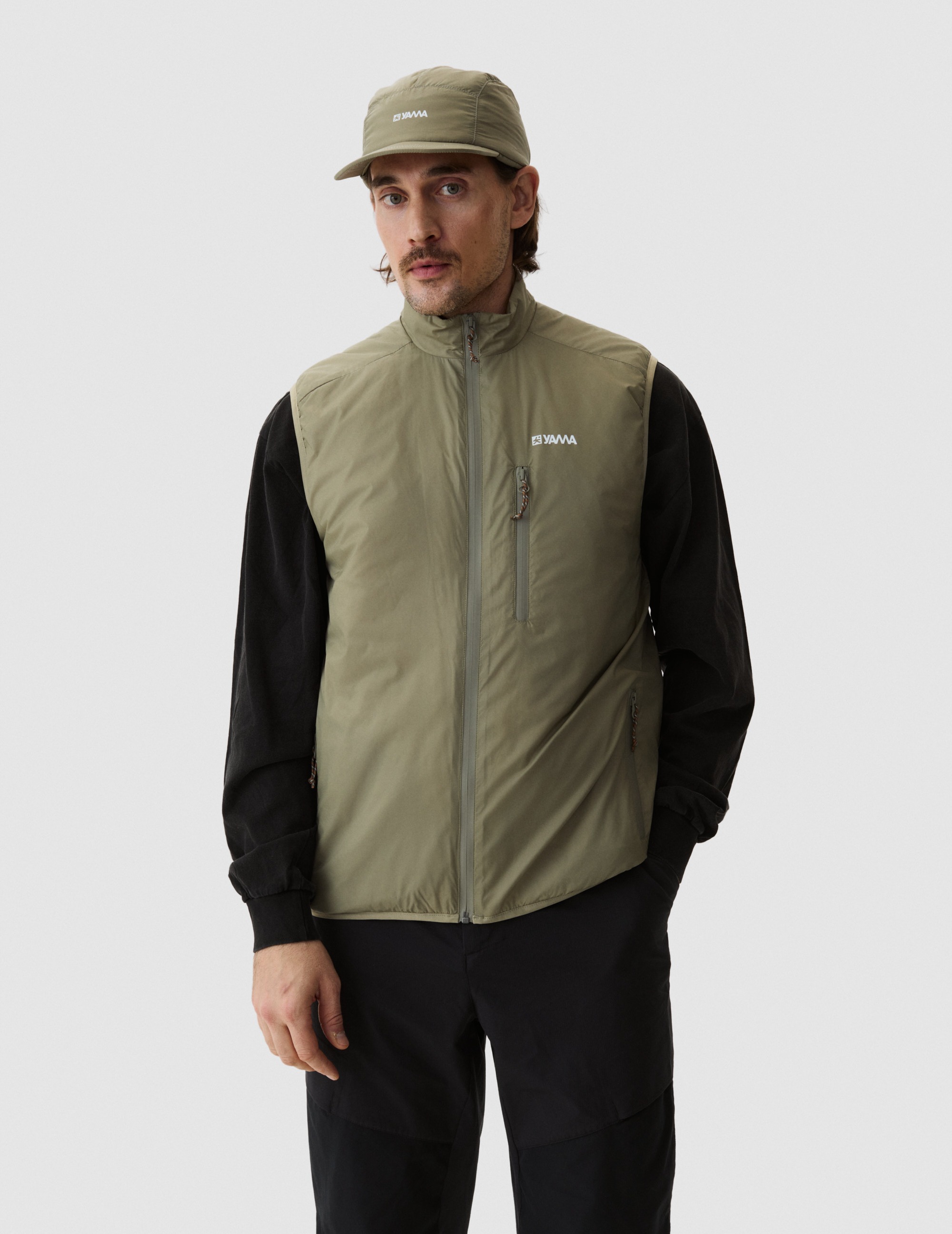 Model wearing Yama Traverse Plain Vest Moss Green