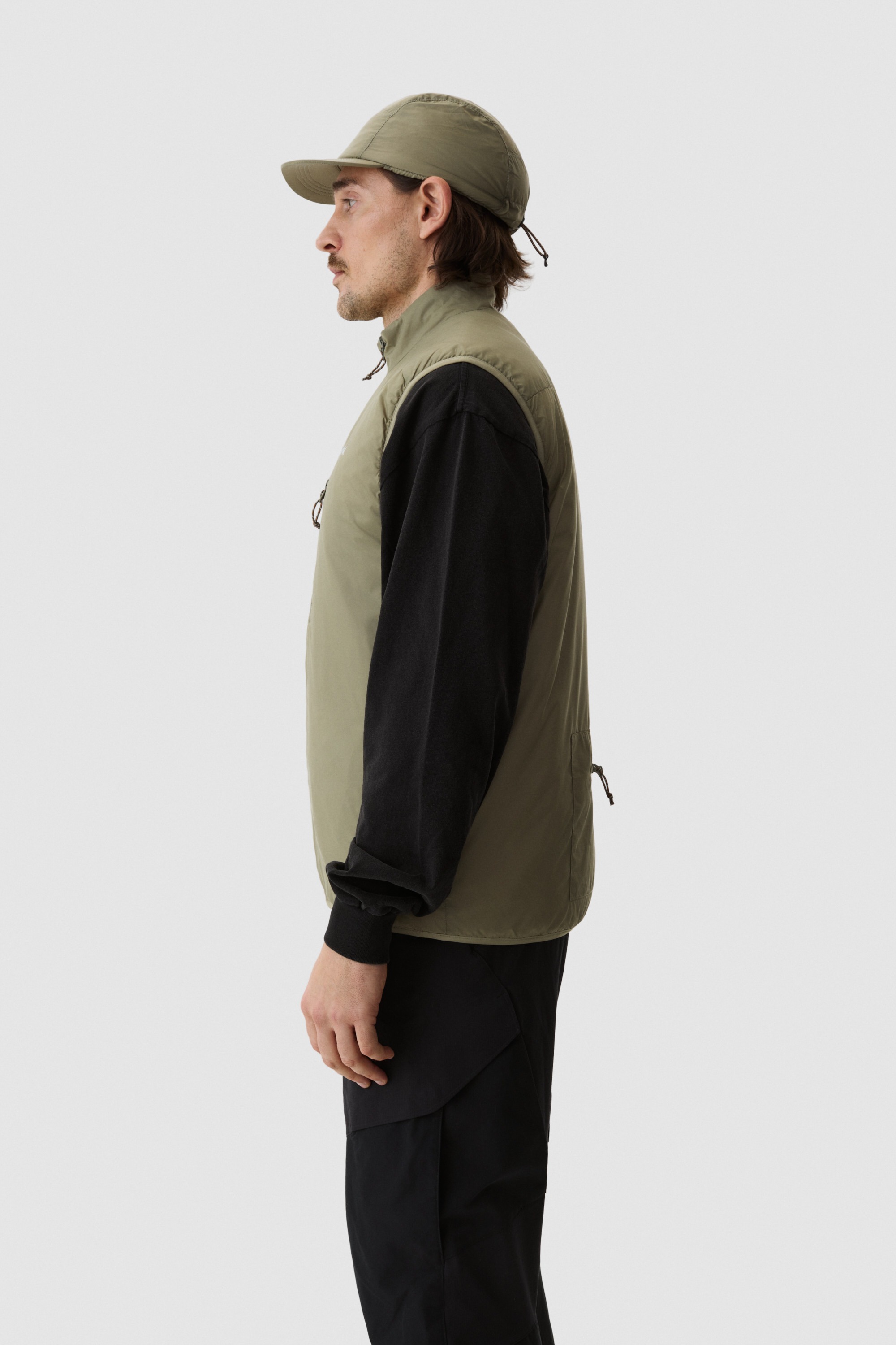 Model wearing Yama Traverse Plain Vest Moss Green